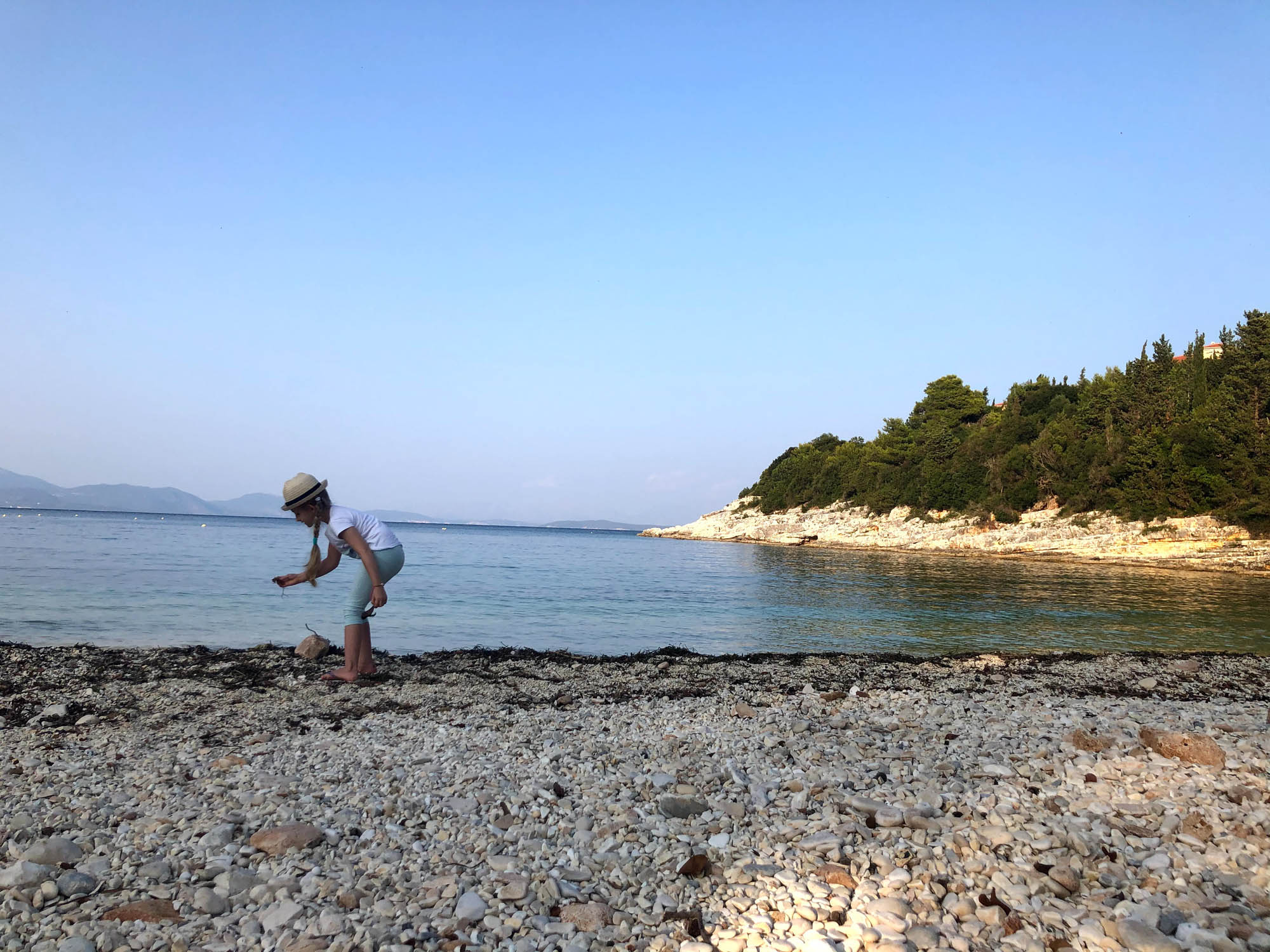 Dziewczynka szukająca muszelek na plaży