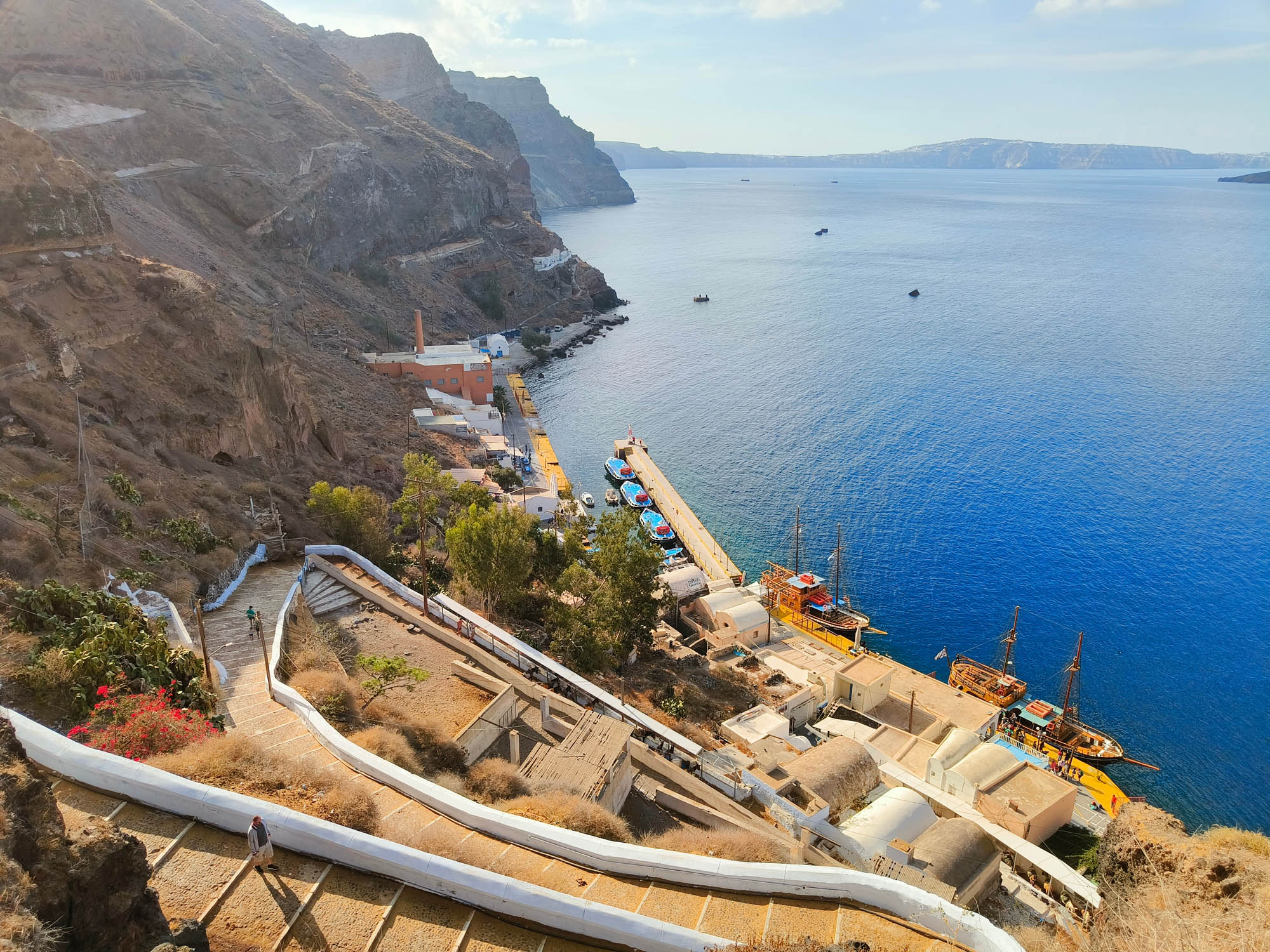 schody prowadzące od starego portu w firze na góre do maista, widok na port i kalderę z góry, santorini